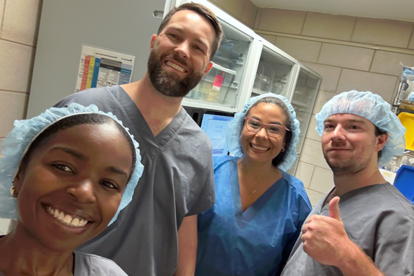 Residents in scrubs in an operating room setting