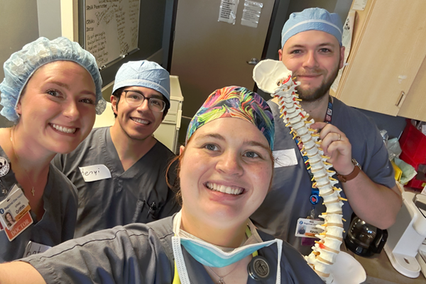 Residents in scrubs in an operating room setting