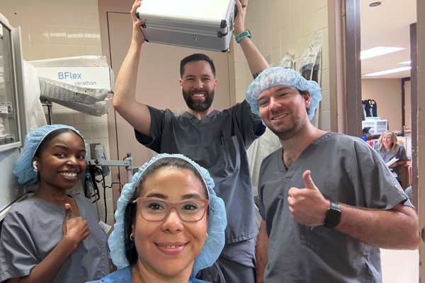 Residents in scrubs in an operating room setting