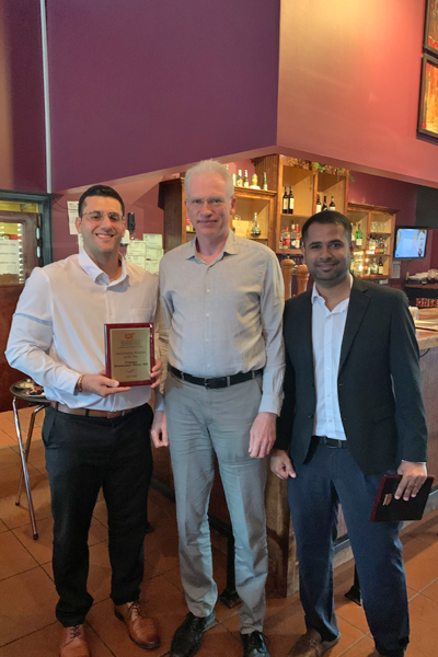 Resident with faculty during graduation