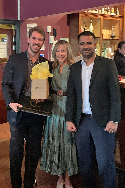 Resident with faculty during graduation