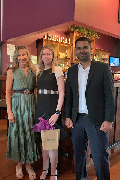 Resident with faculty during graduation