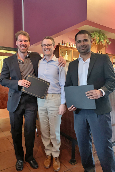 Resident with faculty during graduation