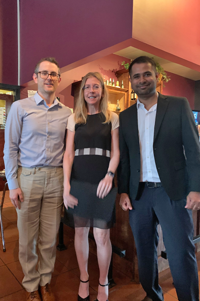 Resident with faculty during graduation