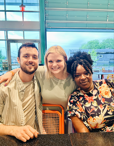 Three residents and faculty members indoors