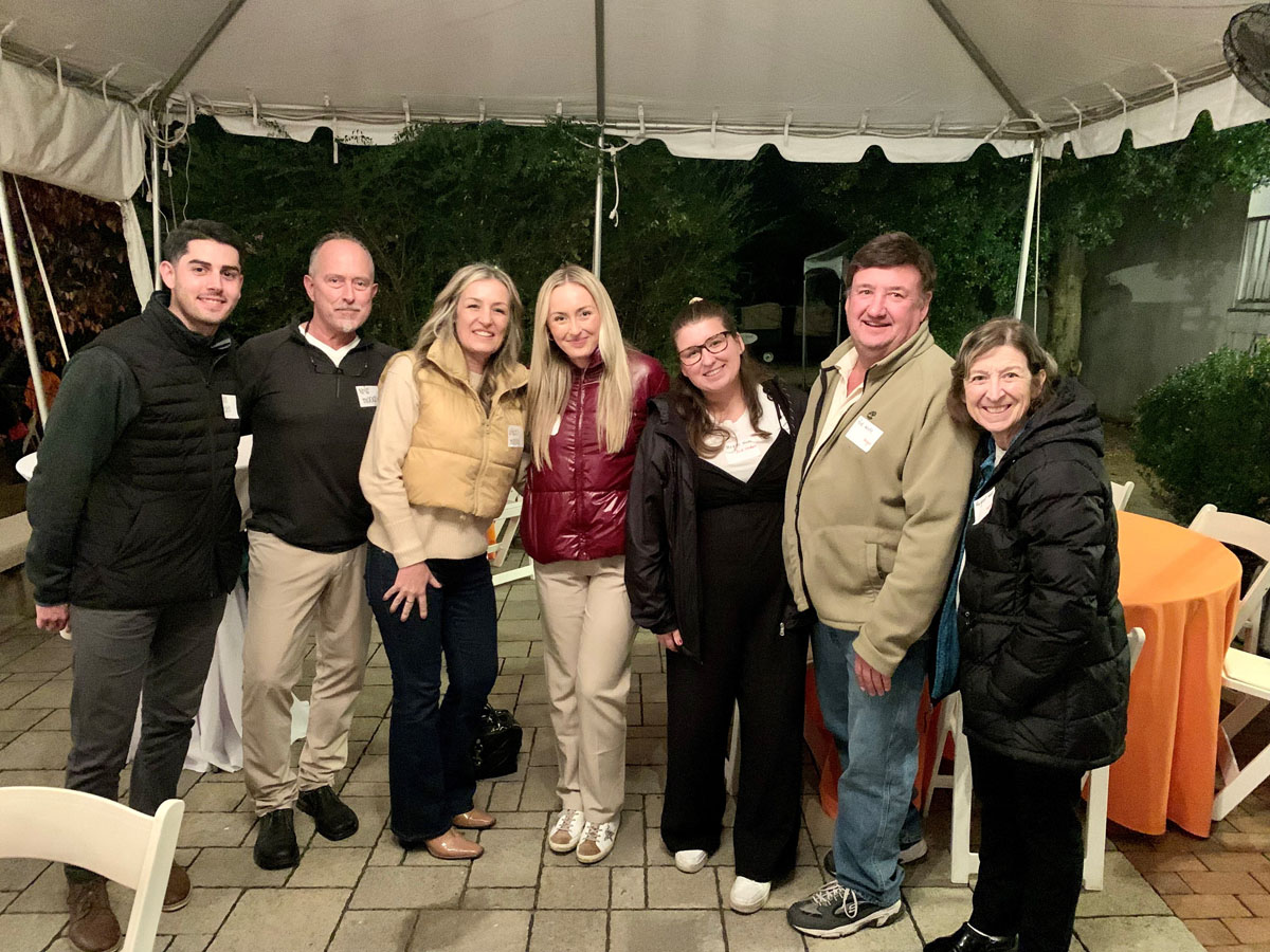 Family Weekend and Alumni Homecoming 2023 photo of a group of alum outside under a tent.