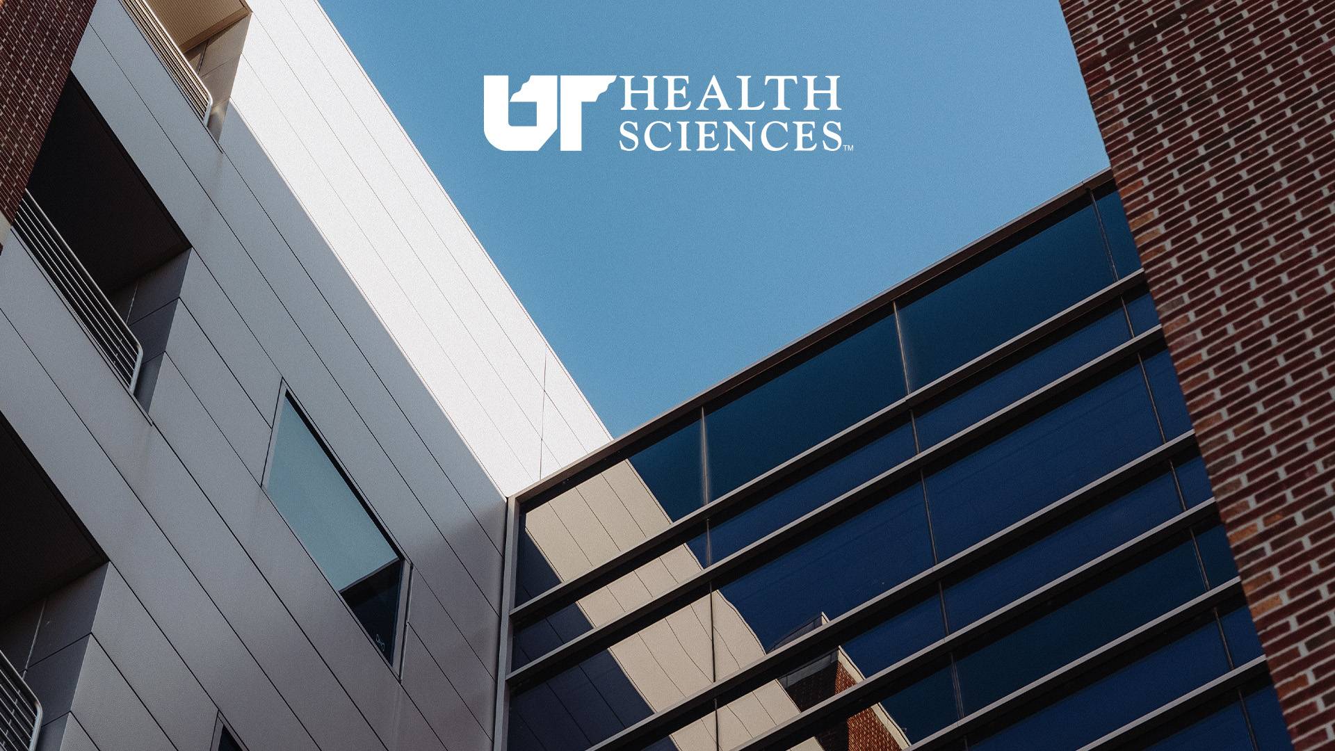 Low-angle view of the straight architectual lines of a campus building with logo.
