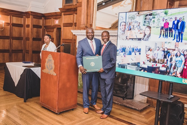 Graduate receiving an award from faculty member