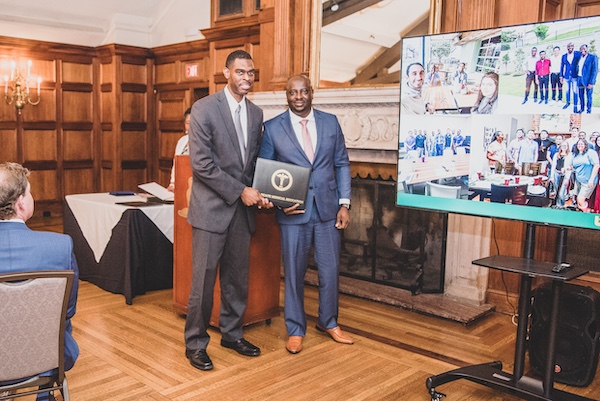 Graduate receiving an award from faculty member