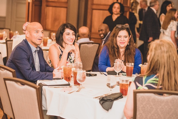 Graduation participants sitting at a table talking