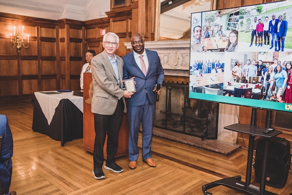 Graduate receiving an award from faculty member