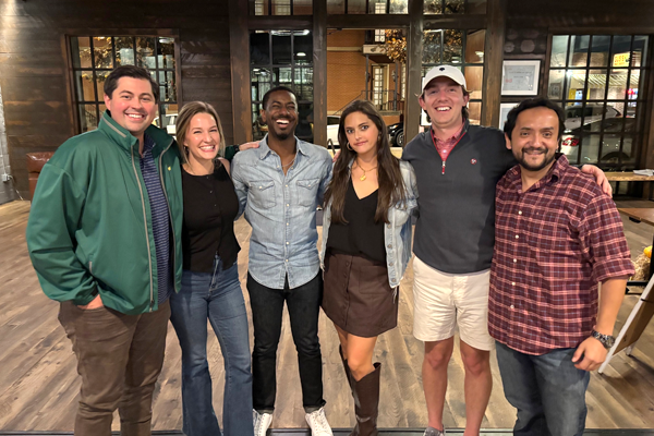 Fellows standing together inside a restaurant