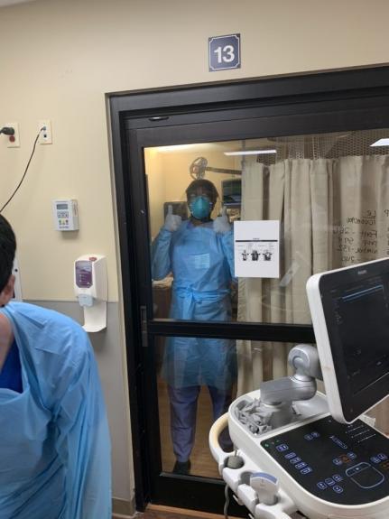 Residents giving a thumbs up in scrubs