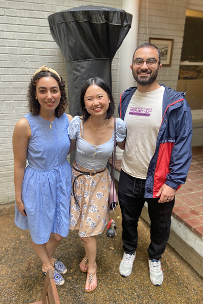 Three residents posing on an outdoor patio