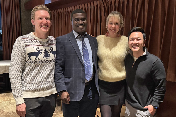 Four people posing at the 2025 graduation venue