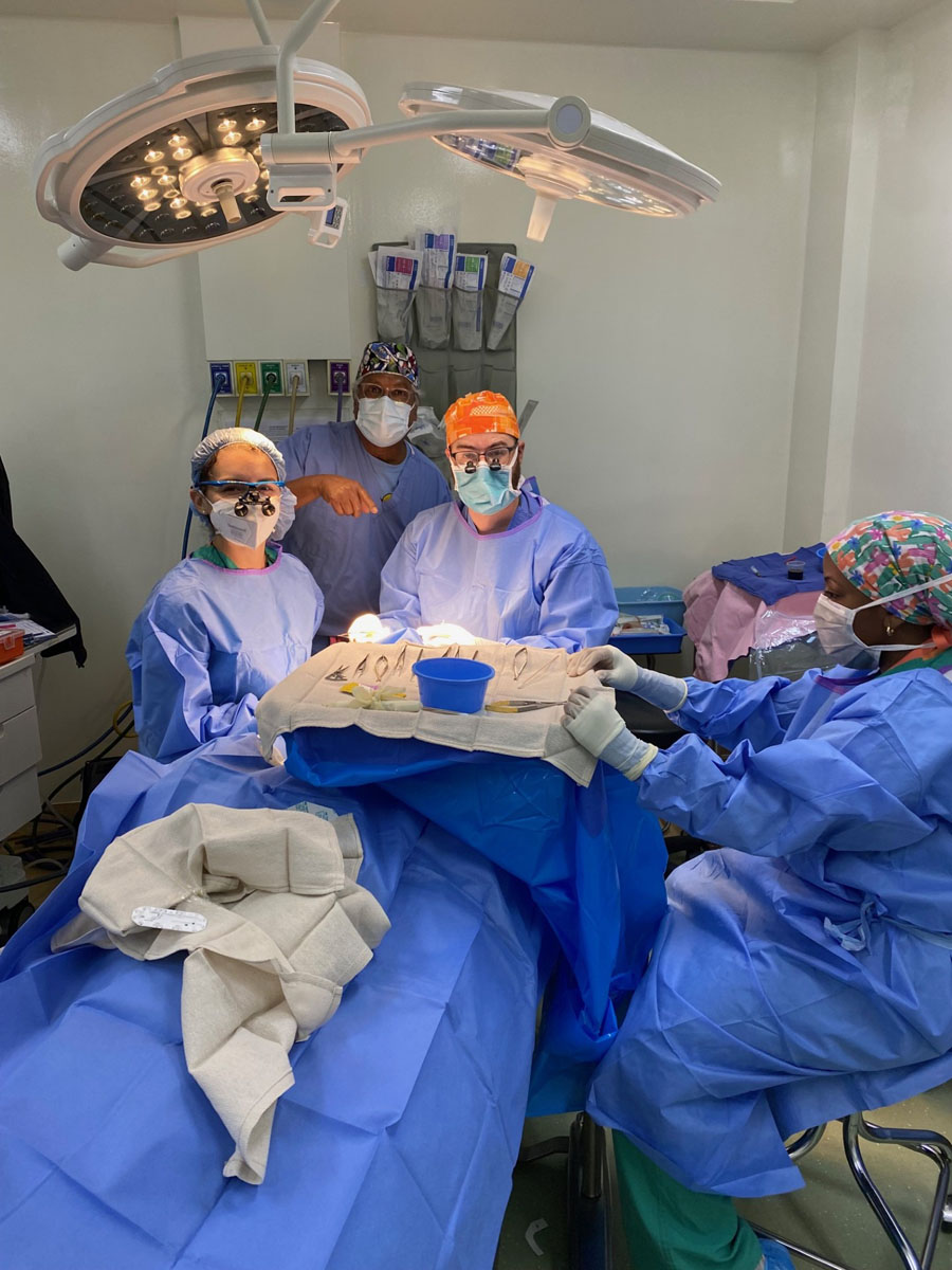 Doctors in operating room working on a patient.