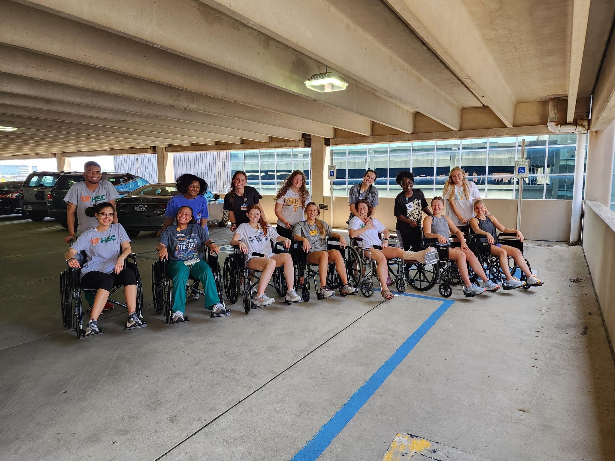OT students with children in wheelchairs that they have helped