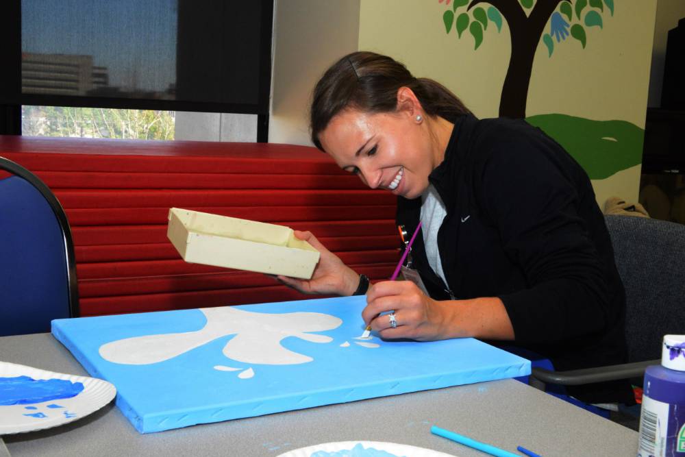 Occupational therapy student painting in the Rachel Kay Stephens Therapy Center.