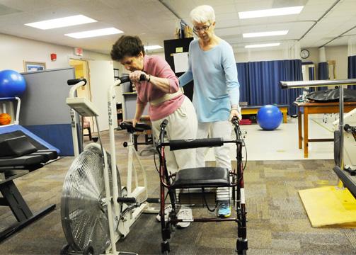 therapist with patient on bike