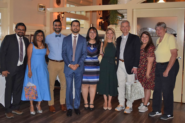 Group photo of fellows, faculty, and family at graduation