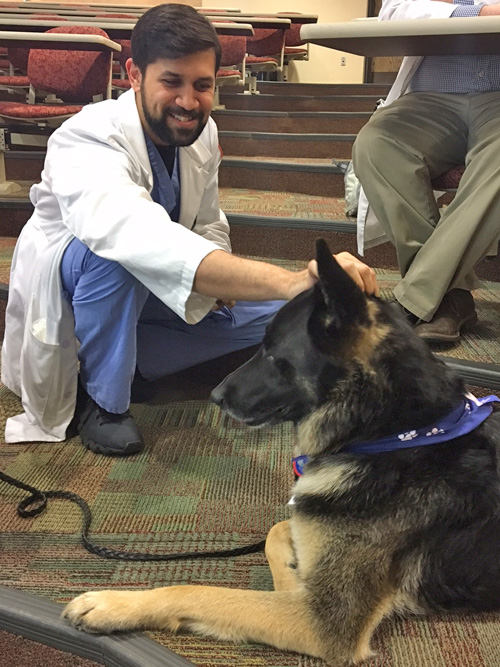 Male residents with a therapy dog