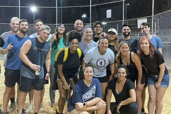 Group photo of residents outside on a baseball field