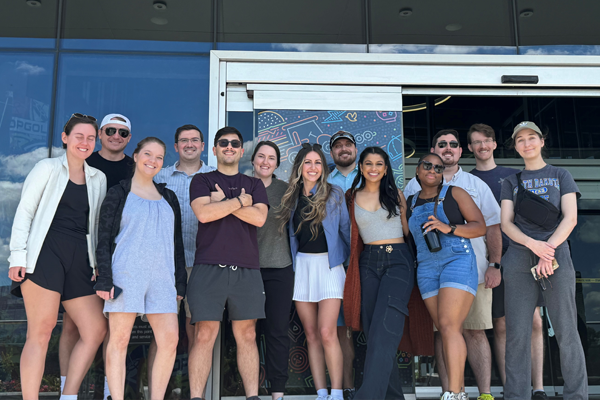 Group of residents standing before a door of a building