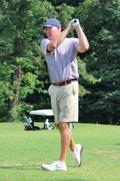 Male resident swinging a golf club
