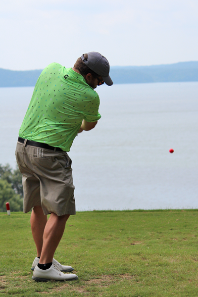 Male resident swinging a golf club