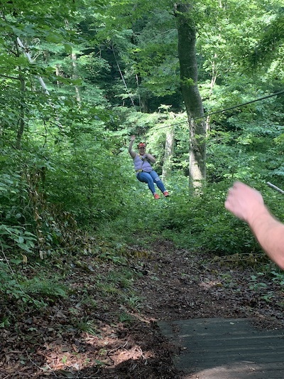 Residents swinging from tree outdoors