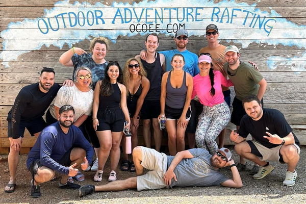 residents doing silly poses in front of the the ocoee sign