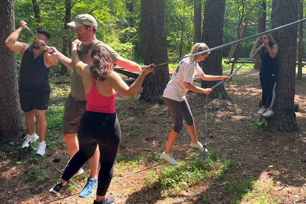 residents outside on a ropes course