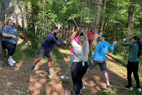 residents outside on a ropes course