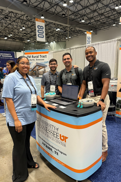 Faculty and residents at their booth on the conference floor