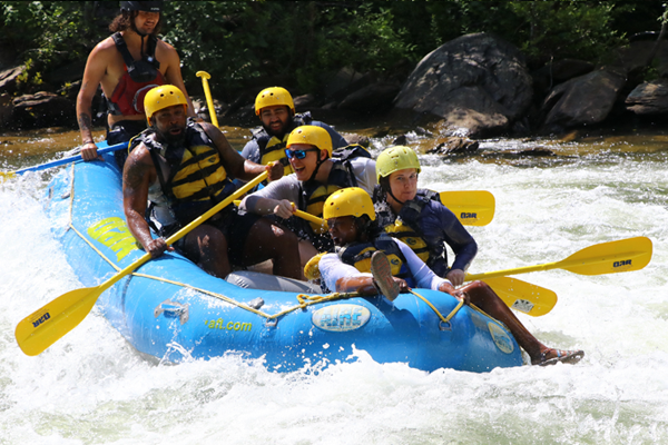 Residents on a raft in the rapids