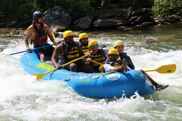 Residents on a raft in the rapids