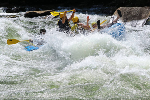 Residents on a raft in the rapids