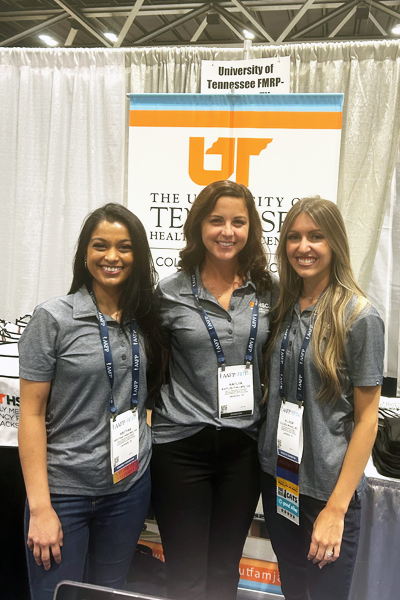 Female residents in front of the Family Medicine booth
