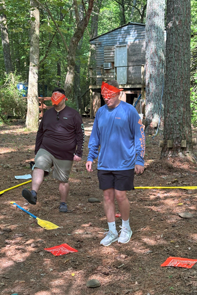 Residents blindfolded for a team building session in the woods