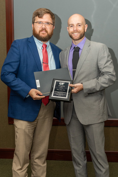 Faculty and resident with award