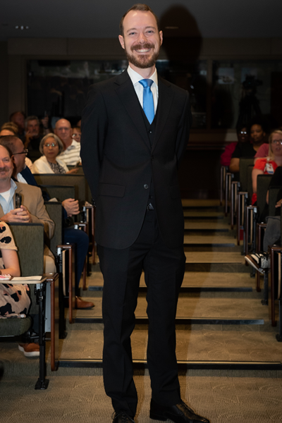 Male resident walking the aisle at graduation