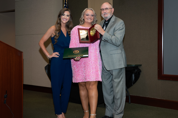 Faculty members with resident holding an award