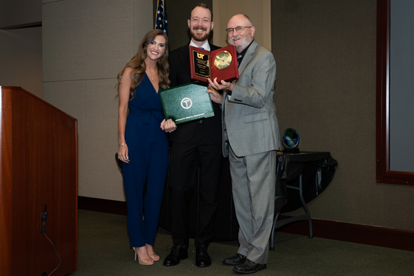 Faculty members with resident holding an award