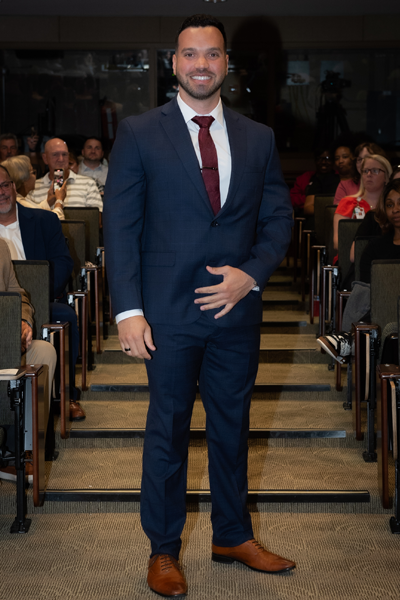 Male resident walking the aisle at graduation