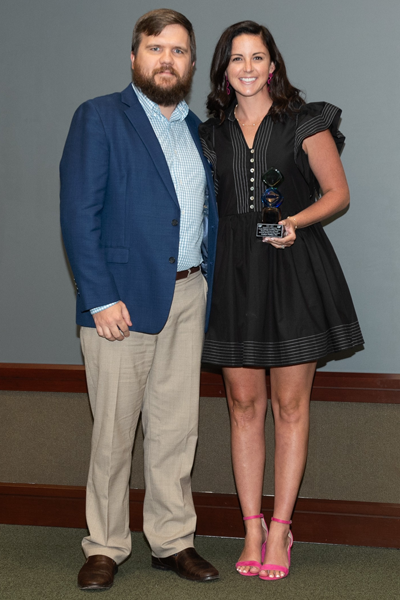 Faculty and resident hold an award at graduation