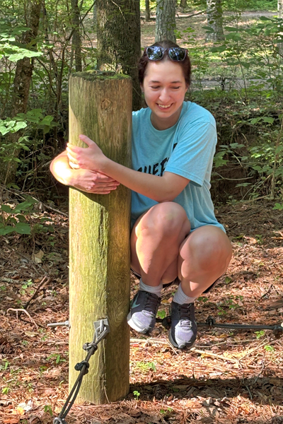 Resident holding on to a wooden pillar as a training exercise
