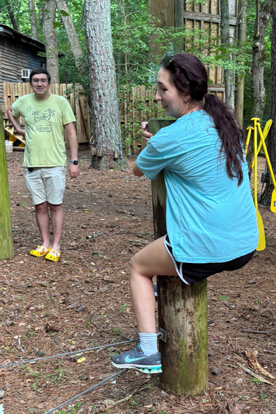 Resident holding on to a wooden pillar as a training exercise