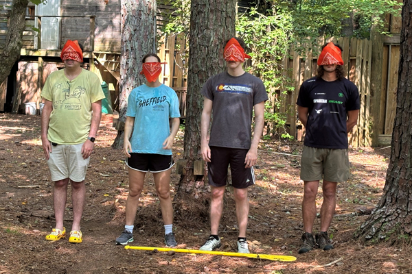 Four residents blindfolded for a team building session in the woods