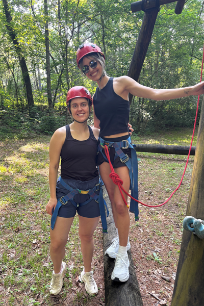 Two female residents holding on to a wooden pillar as a training exercise