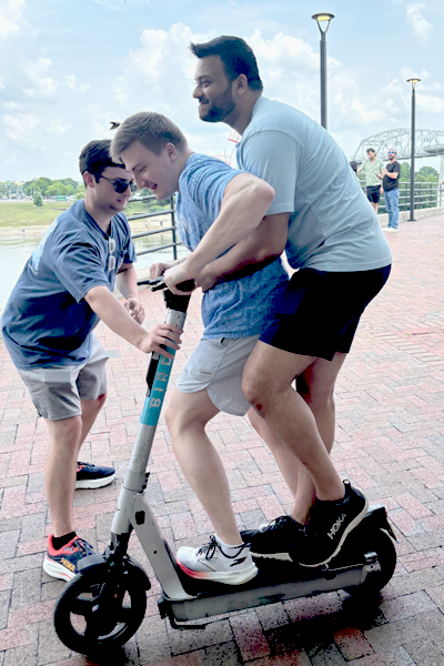 Residents riding a scooter